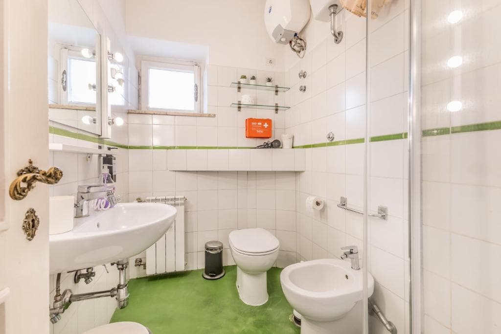 Bathroom with WC, bidet, washbasin and twin windows