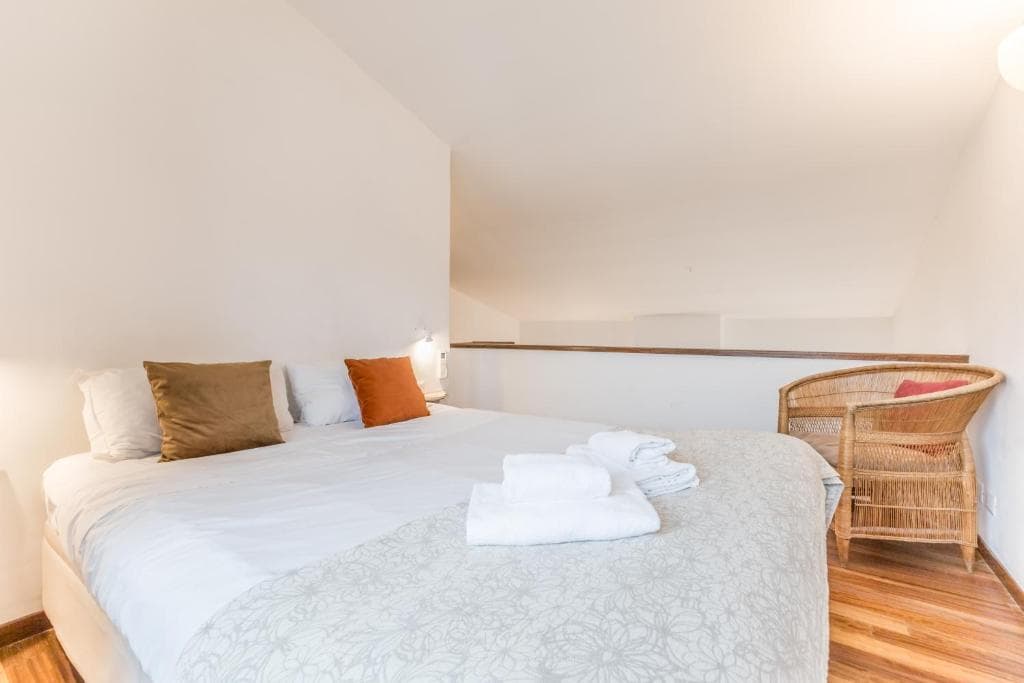 Mezzanine bedroom with double bed beside the loft railing