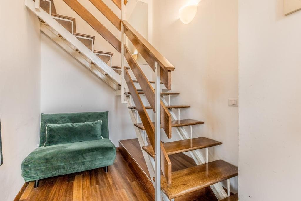 Internal wooden staircase leading up to the mezzanine bedroom