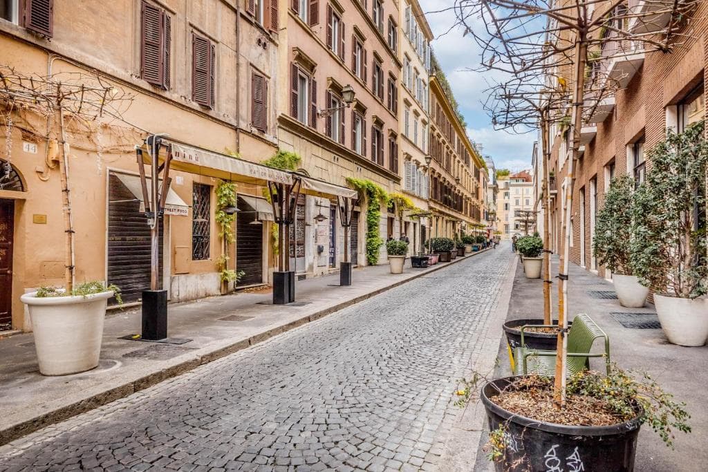 Quiet cobblestone street of historic buildings near Via della Frezza